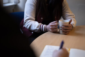 women with cup of coffee at the table