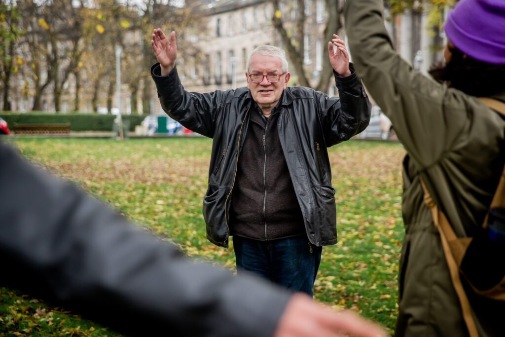 A man with hands in the air - David story about isolation and loneliness