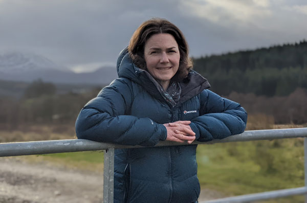 Women standing with mountain behind her - Rural Connections