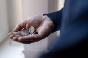 hand with coins - money worries and mental health