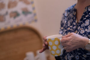 person with a mug standing