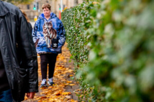 Two people walking with orange leaves on the pavement - rural mental health