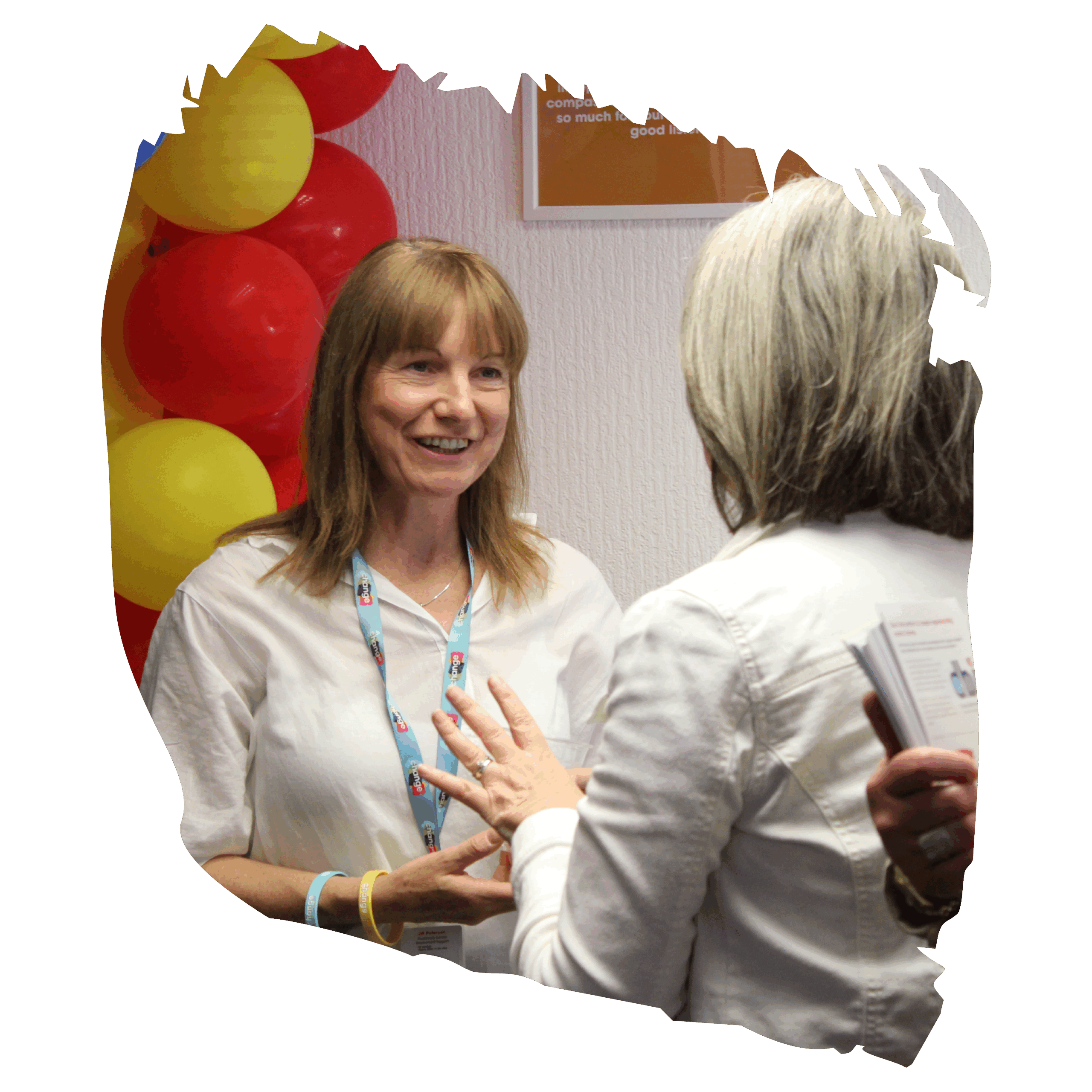 two women having conversation with balloons in the background