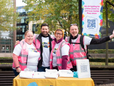 Volunteers Week - 4 people standing in Change Mental Health T-shirts at the event stand