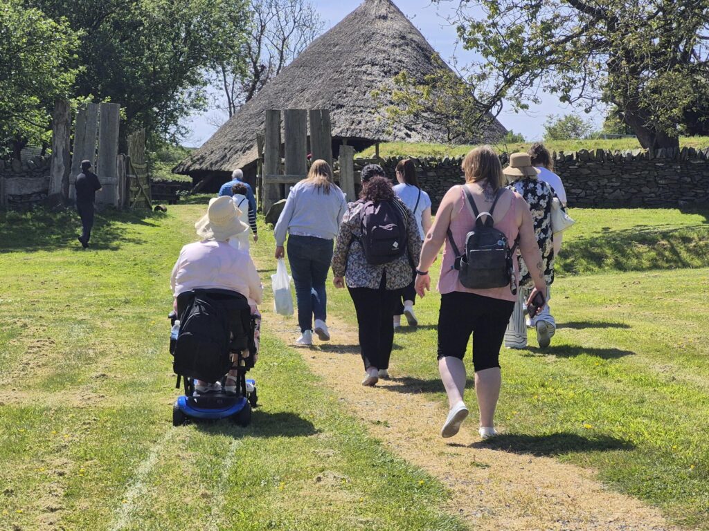 group of people during walking group and a wheelchair user. Physical activity doesn't have to mean running, even being outside can be good