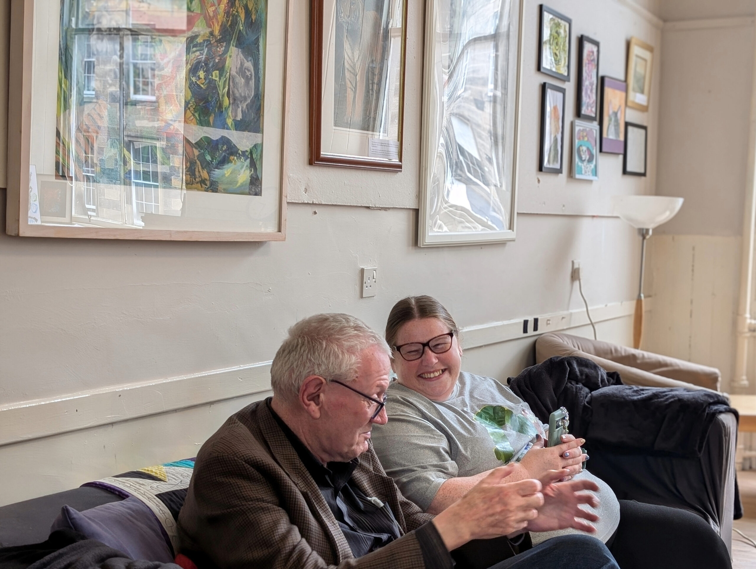 Two people on a sofa in Change Mental Health resource centre