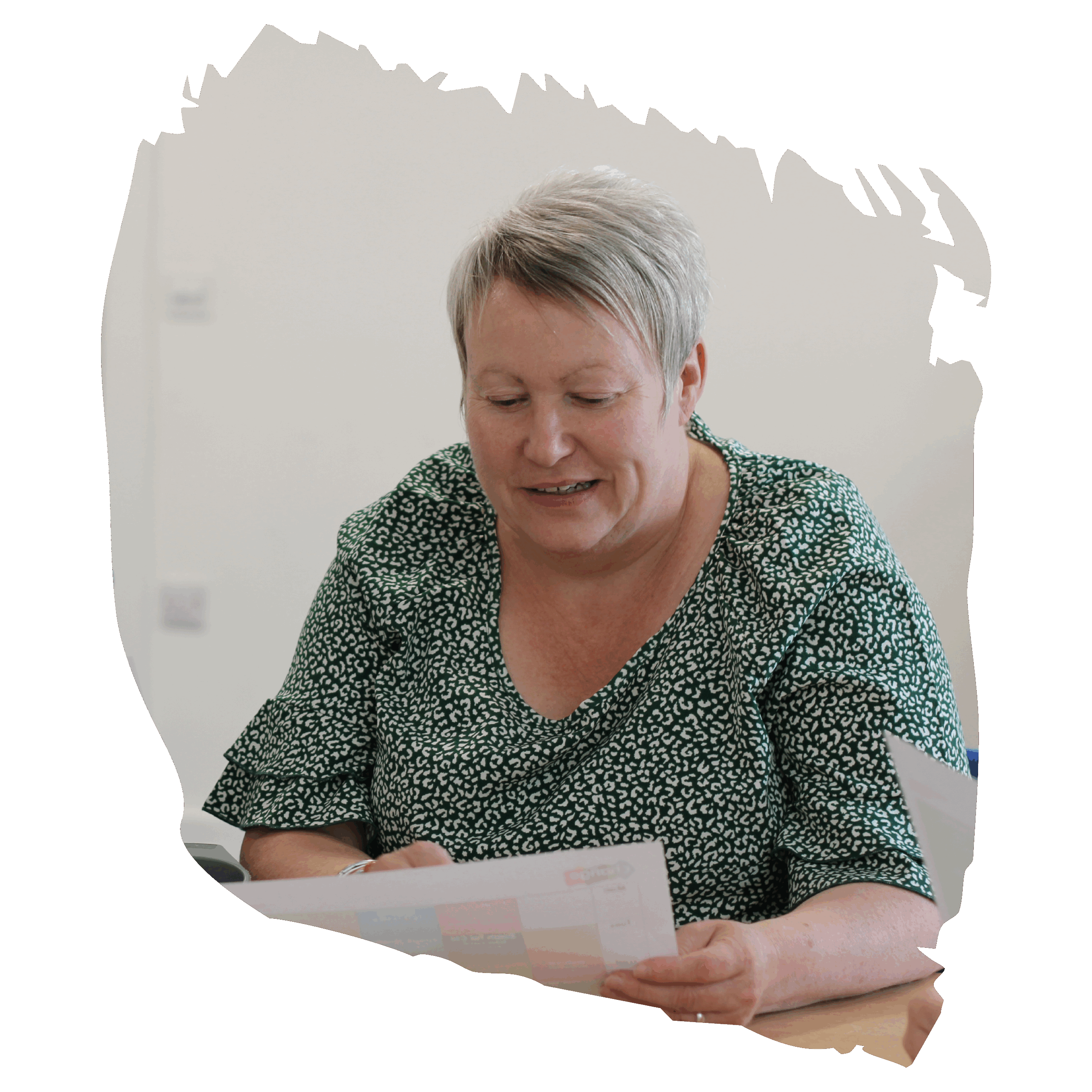 women in green spotty blouse reading papers