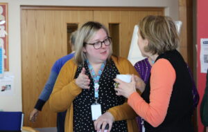 supporting other with their mental health - two women chatting over the coffee