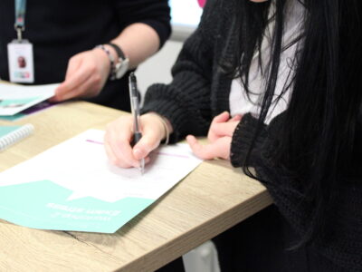 A women writing during Me&Money workshop