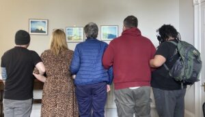 Hearing Voices group together holding arms - only back visible to show stigma