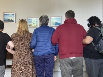 Hearing Voices group together holding arms - only back visible to show stigma