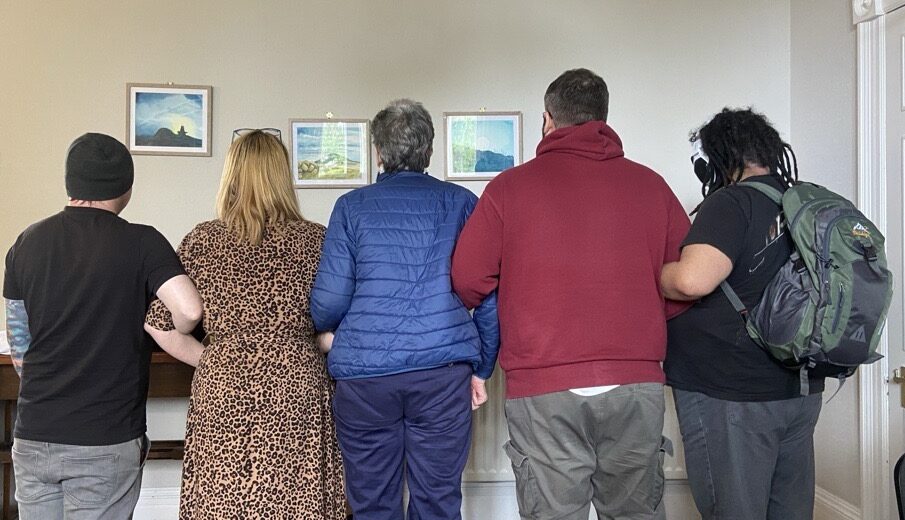 Image 27 - Change Mental Health Hearing Voices group together holding arms - only back visible to show stigma
