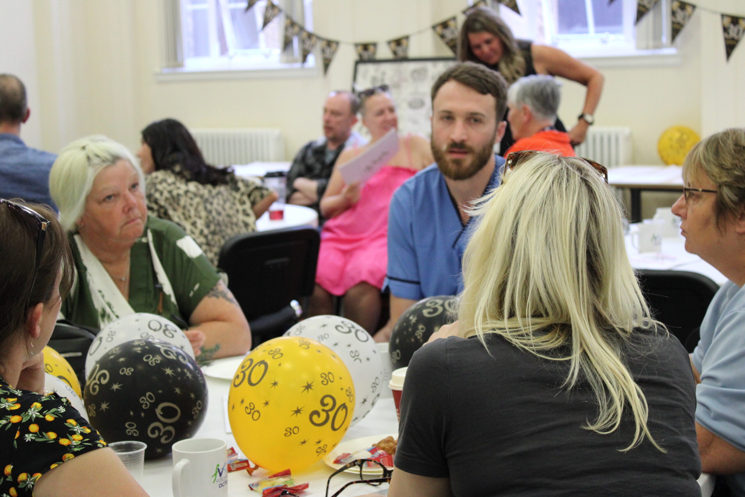 Hearing Voices - Change Mental Health A group of people with baloons saying 30 - hearing voices 30th anniversary
