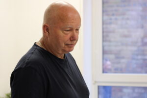 A man standing next to window - When service ends, caring begins: Help for Angus carers of veterans