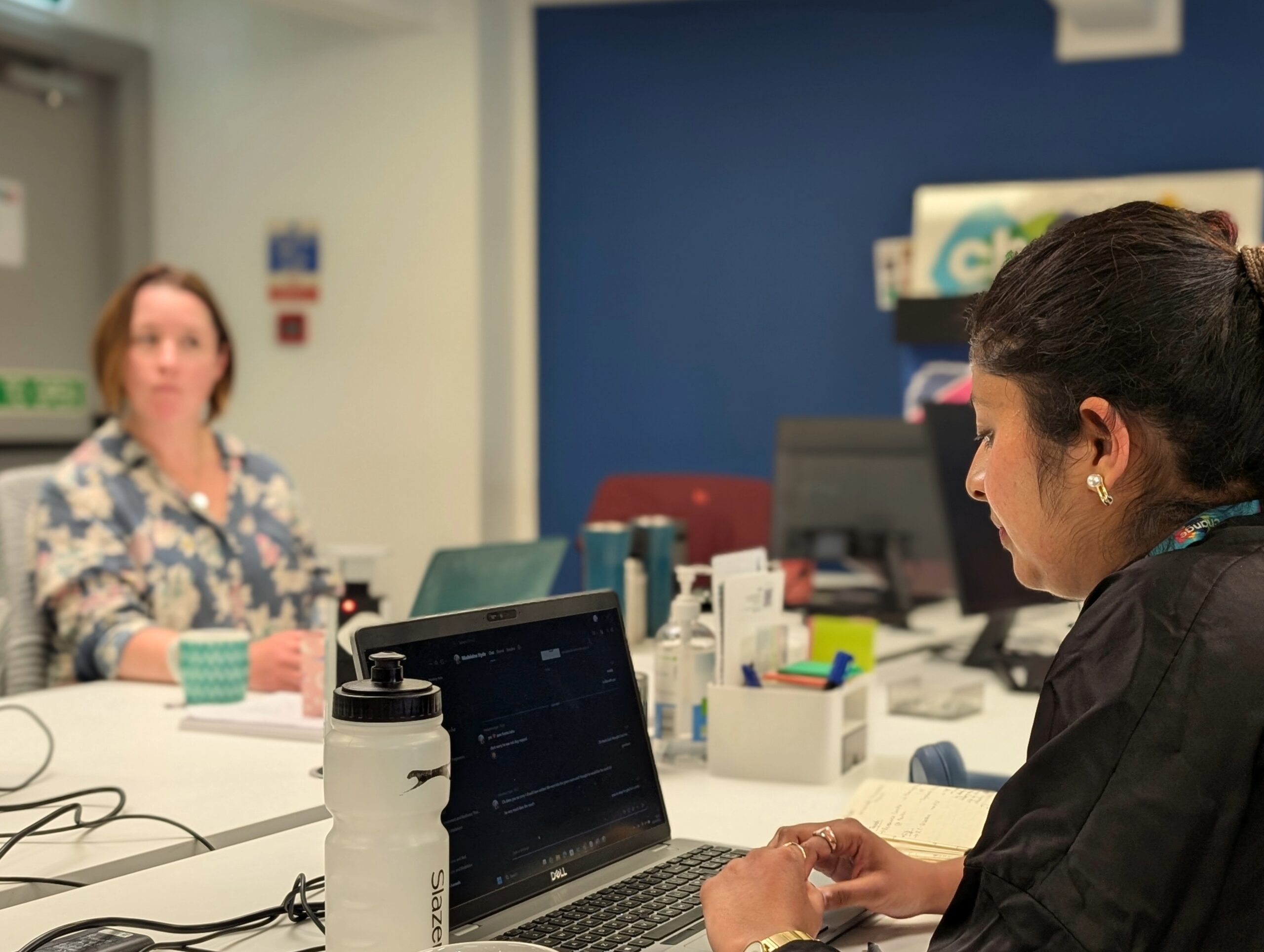 mental health support work - women in the Change Mental Health office with laptop