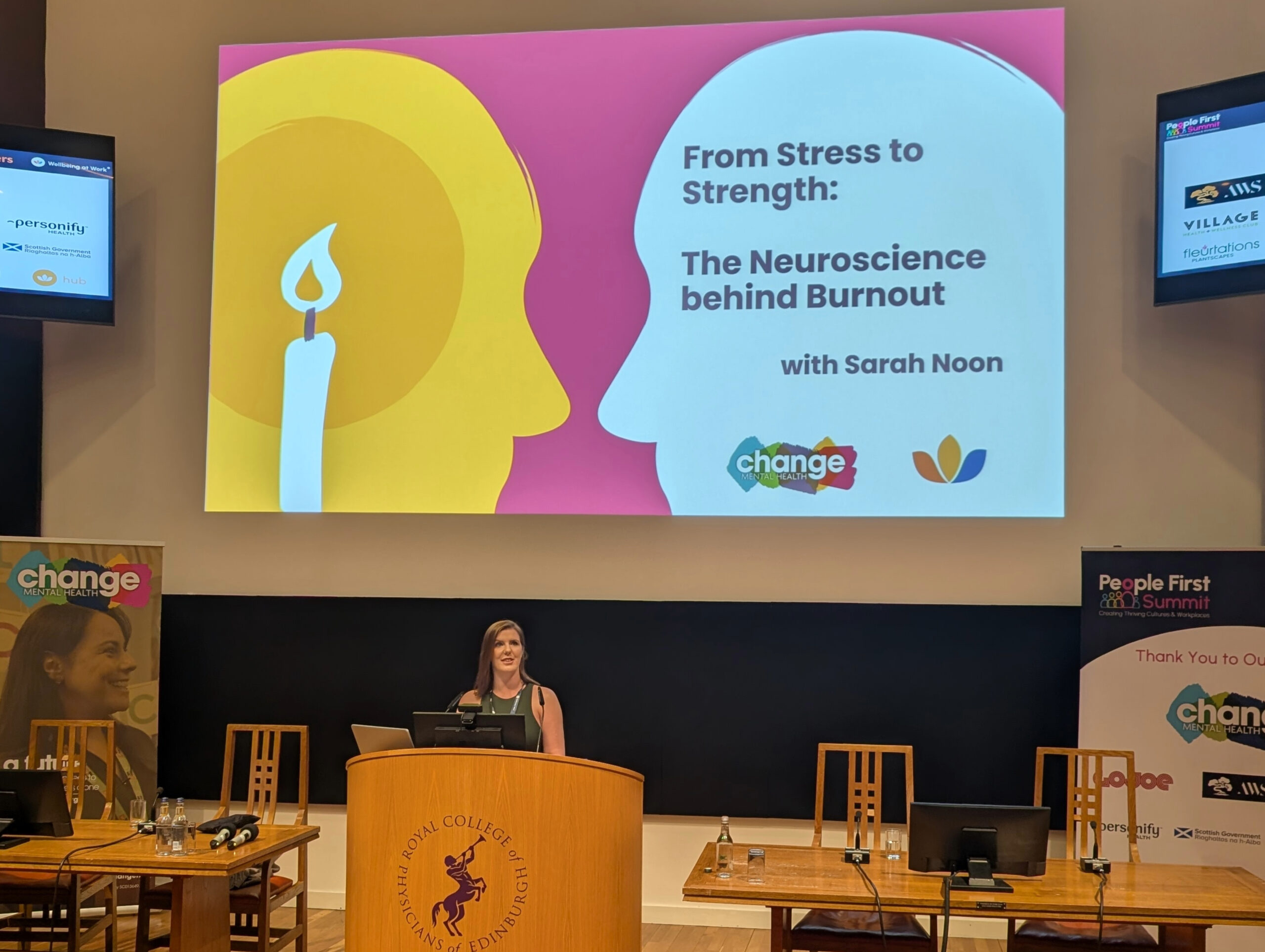 Sarah Noon during presentation - Change Mental Health Women during the presentation with title saying: From stress to strength: The neuroscience behind burnout