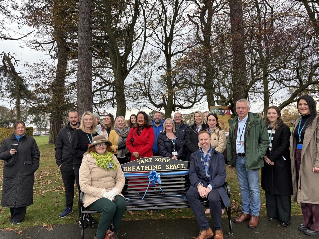 From left, seated – Cllr. Lesley Backhouse and Nick Ward, CEO of Change Mental Health. Standing behind and around the bench (from left to right) are Cllr. Julie MacDougall in red, Cllr. Kathleen Leslie, Cllr. Ian Cameron, and Lisa-Jane Dock from NHS 24 Breathing Space, alongside local partners including members of Andy’s Men’s Club, staff from Gillespie Macandrew, and representatives from Fife Council, Fife Health and Social Care Partnership, and NHS Fife.