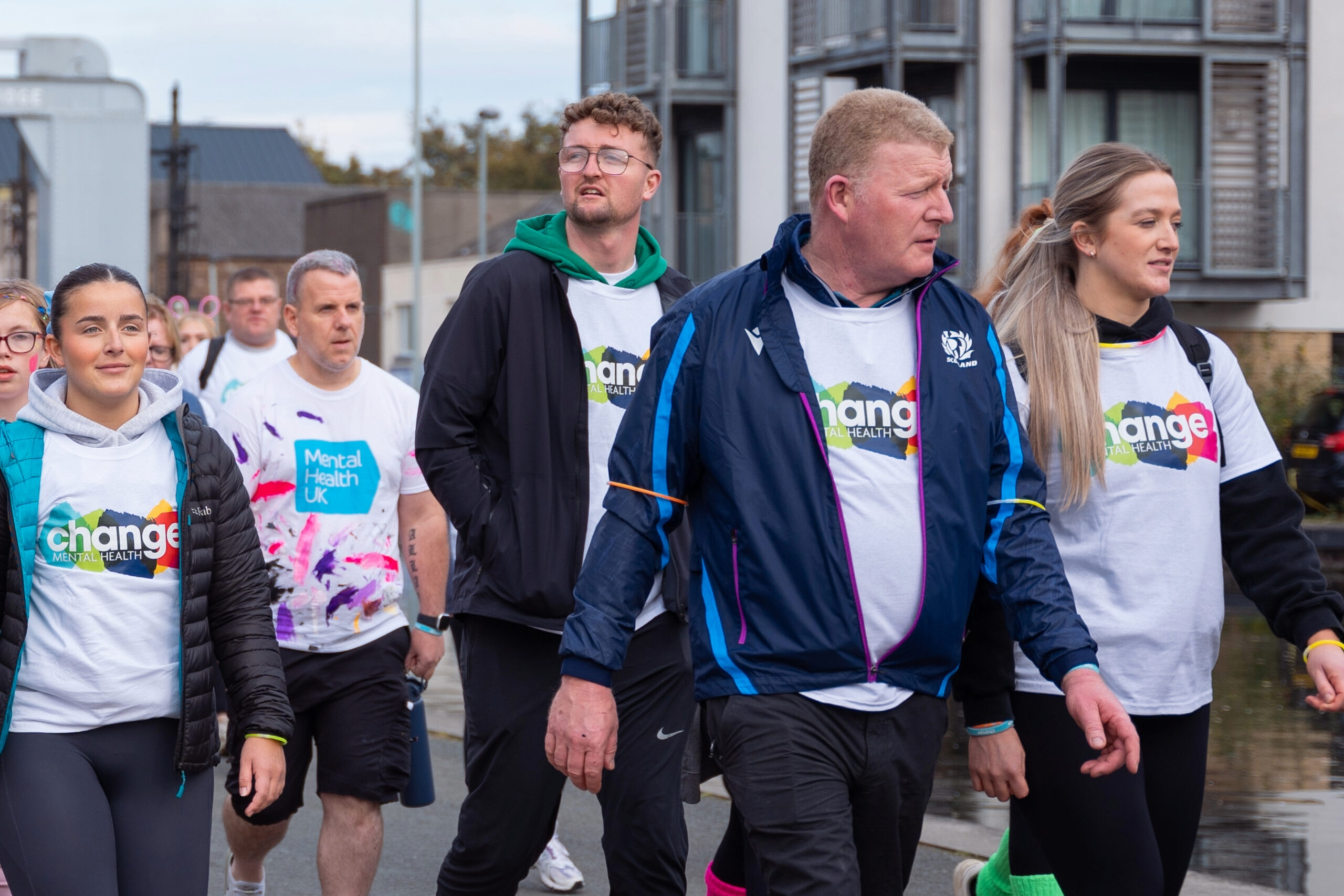 Annual Report 2024/25: Celebrating increased impact and wider reach photo of people walking in Change Mental Health t-shirts