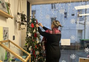 christmas pop up shop and a route back to work - volunteer from employability support project decorating christmas tree