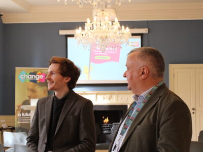 two man standing in conversation with change mental health banner in the background: Jamie Grant(Policy and Public Affairs Manager) and Jim Hume (Director of Public Affairs and Communication) - symbolising mental health policy influencing in Scotland