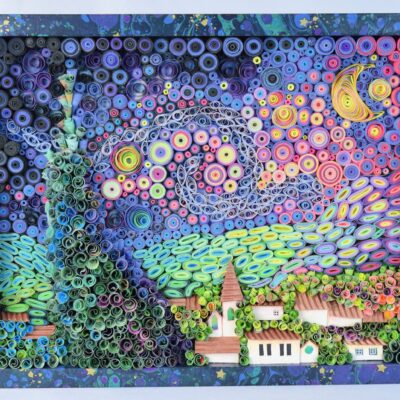 Quilled paper landscape with spiraled colored rings forming trees, hills, and houses inside a decorative frame.